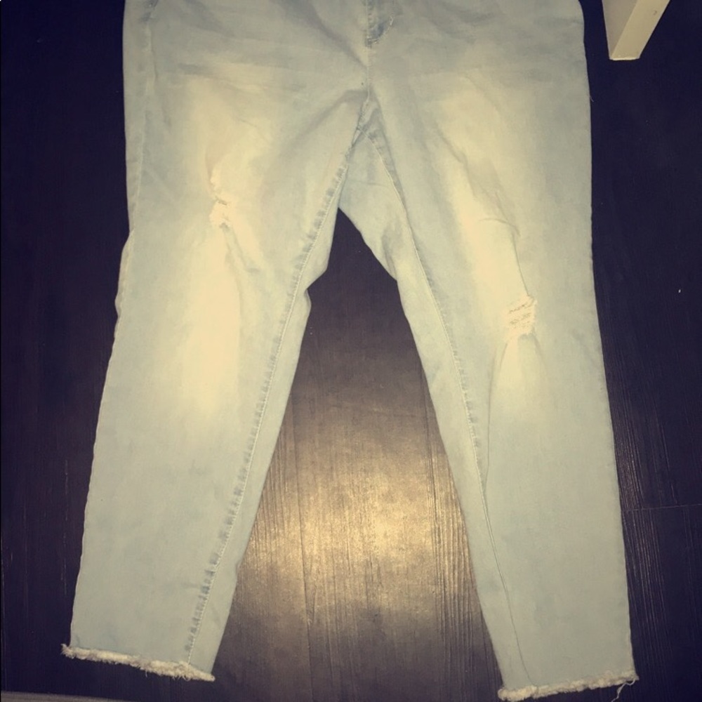 light blue wash jeans with a fringe ankle cut